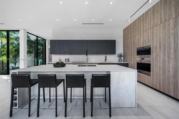 a view of kitchen with granite countertop lots of counter top space and furniture