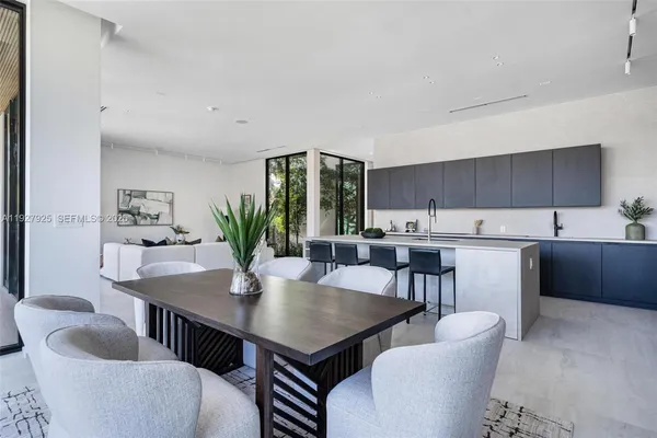 a living room with couches and potted plants