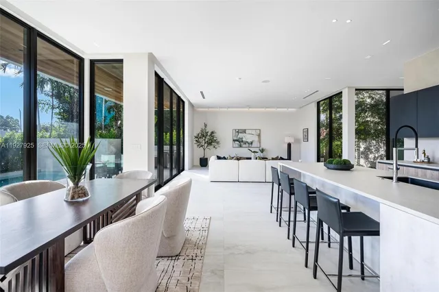 a view of a dining room with furniture one side kitchen view