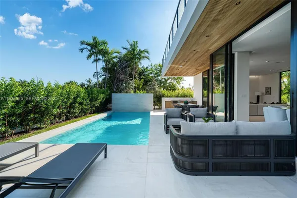 a view of a patio with couches and potted plants