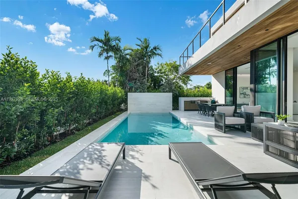 a view of a patio with couches table and chairs with potted plants