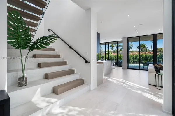 a spacious bedroom with a bed and a large window