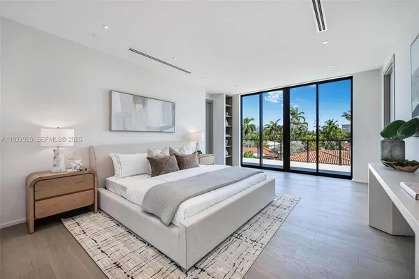 a bedroom with a bed and a view of kitchen