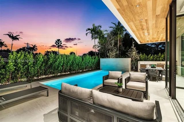 a view of outdoor sitting area with furniture and a garden