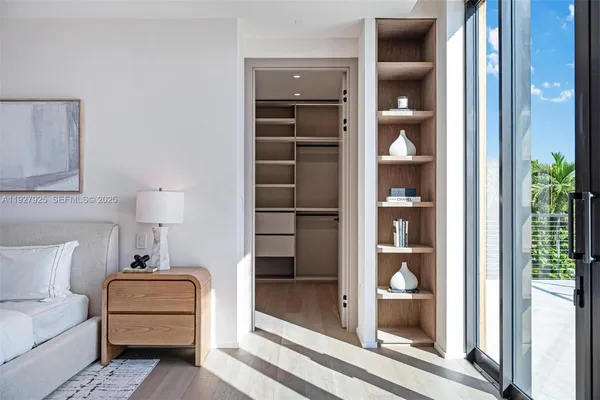 a view of walk in closet with empty racks