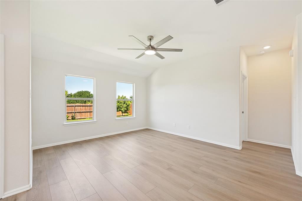 857 Watson Way Crowley, TX 76036 - Photo 11 of 25 Spacious room with light wood-finish flooring, two large windows, a contemporary ceiling fan, and recessed lighting
