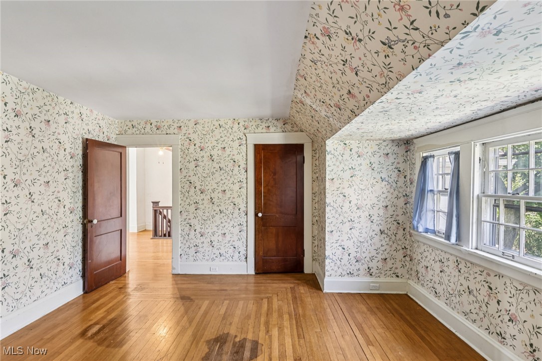 4040 Bayard Road Cleveland, OH 44121 - Photo 34 of 49 Unfurnished bedroom featuring light wood-type flooring and wallpapered walls