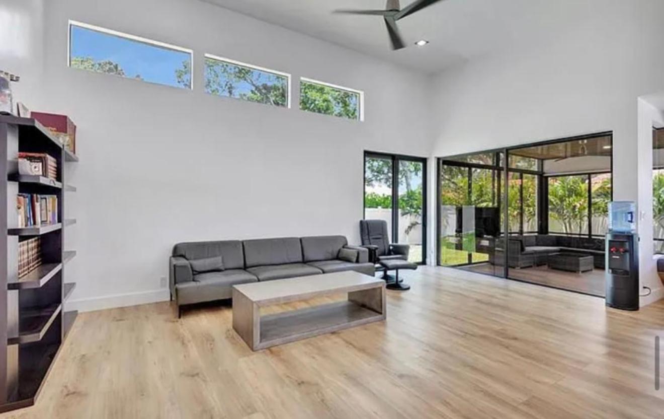2299 Northwest 55th Street Boca Raton, FL 33496 - Photo 16 of 47 a living room with furniture and a flat screen tv