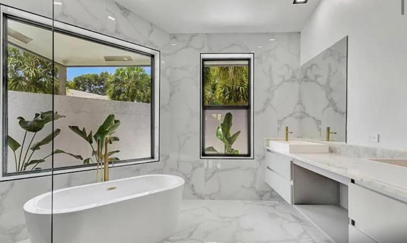 2299 Northwest 55th Street Boca Raton, FL 33496 - Photo 18 of 47 a bathroom with a sink and a bathtub