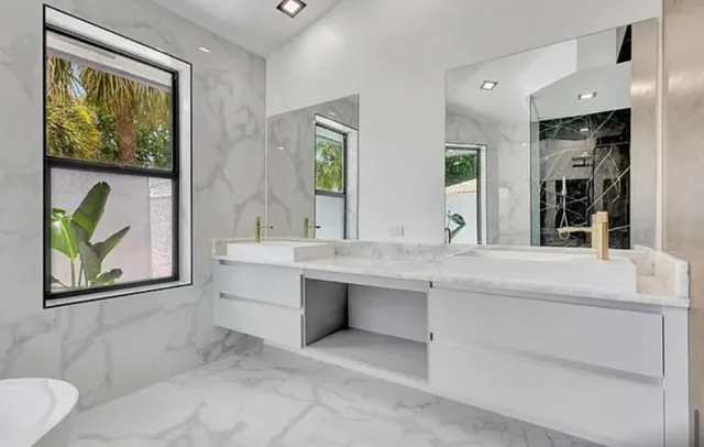 a bathroom with a sink and a large mirror