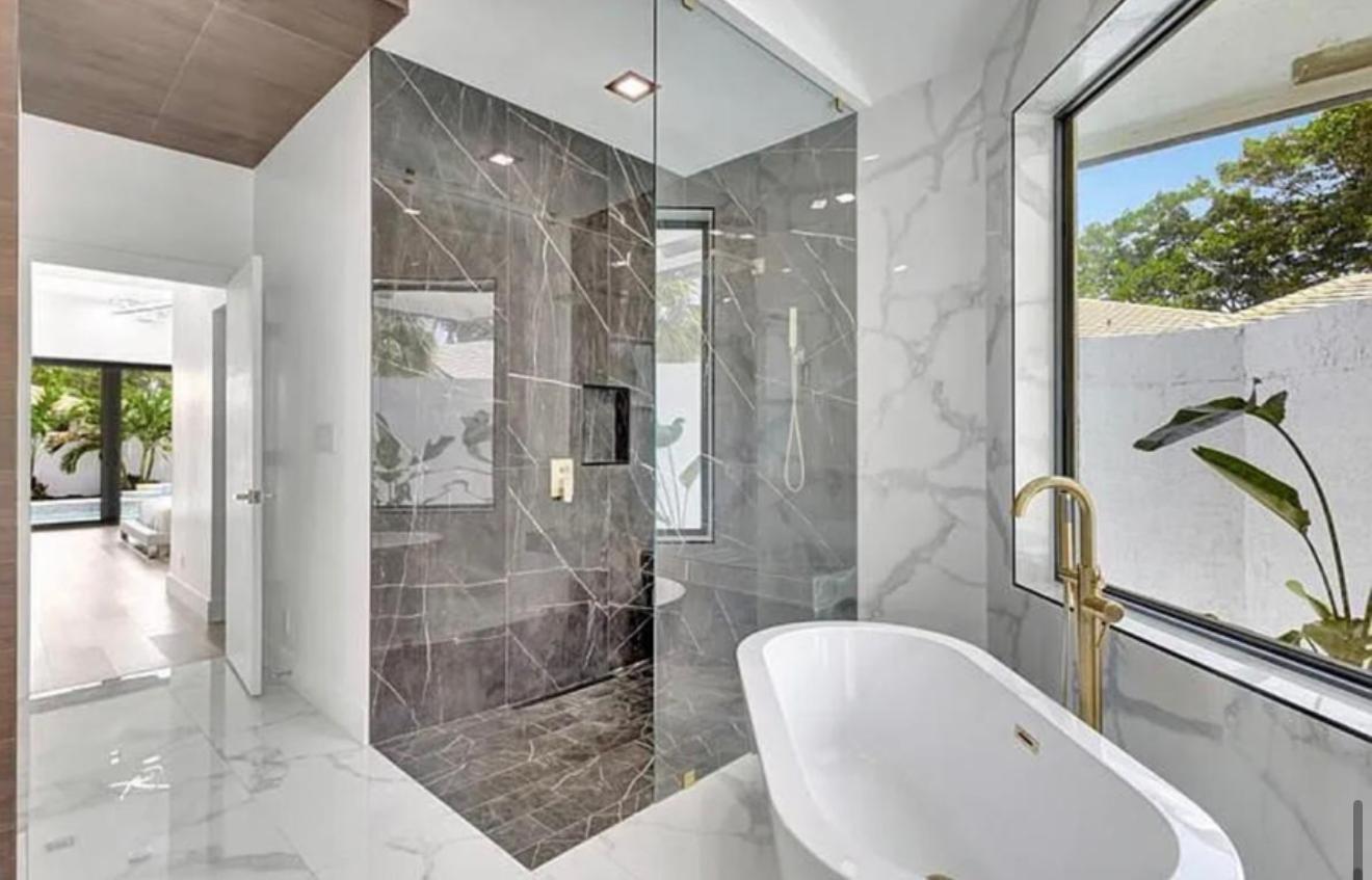 2299 Northwest 55th Street Boca Raton, FL 33496 - Photo 20 of 47 a bathroom with a tub shower and sink