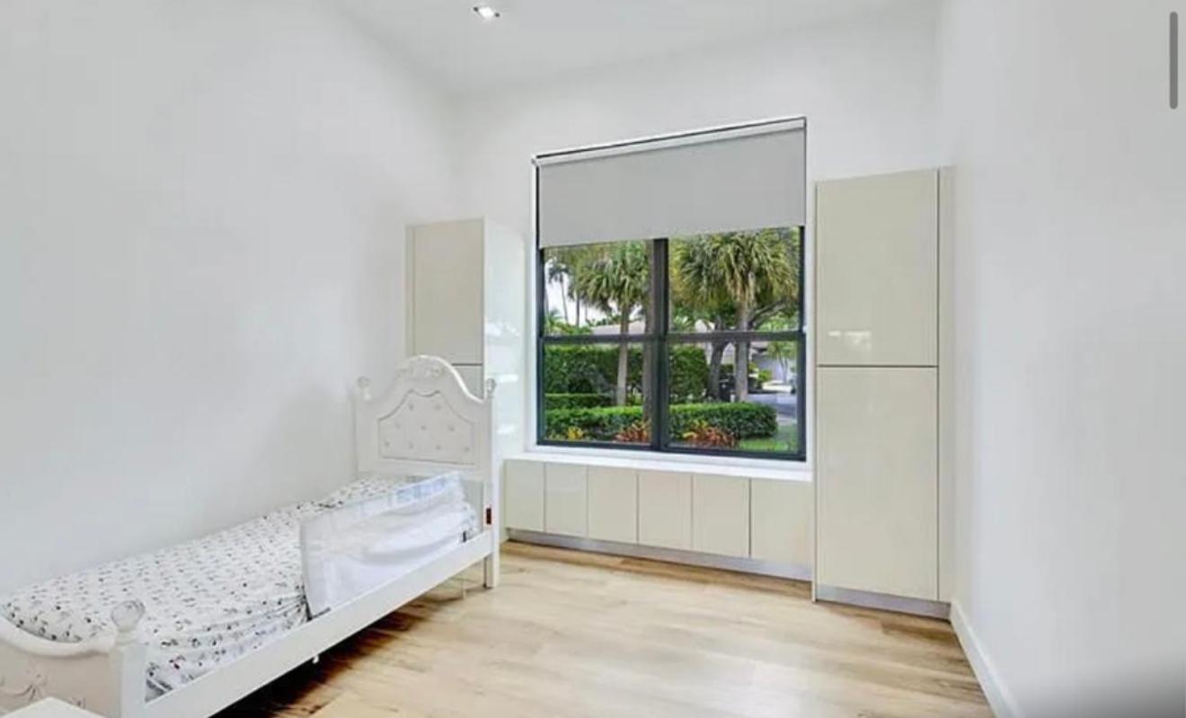2299 Northwest 55th Street Boca Raton, FL 33496 - Photo 22 of 47 a living room with furniture and a window