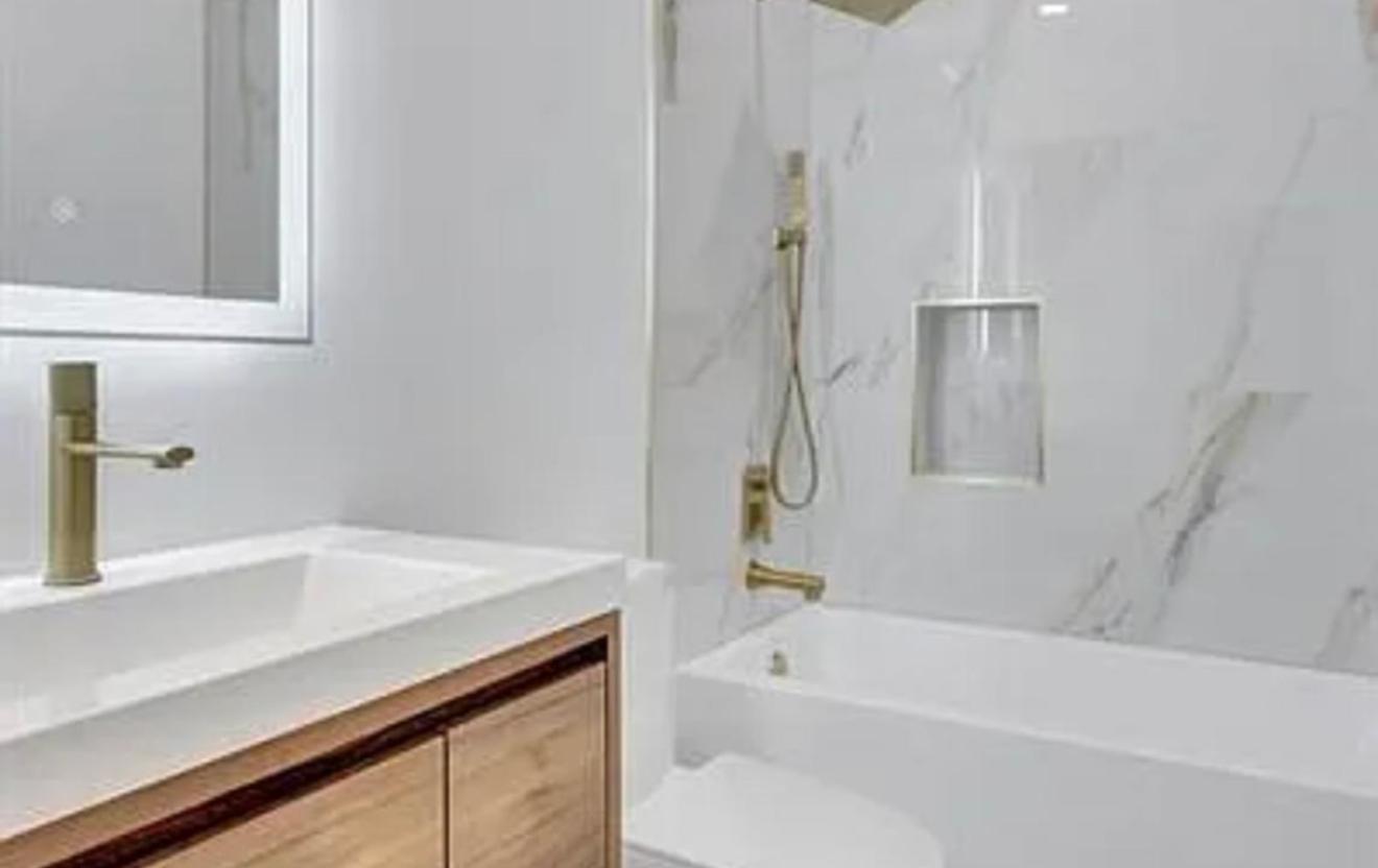 2299 Northwest 55th Street Boca Raton, FL 33496 - Photo 23 of 47 a bathroom with a sink a bathtub and a shower