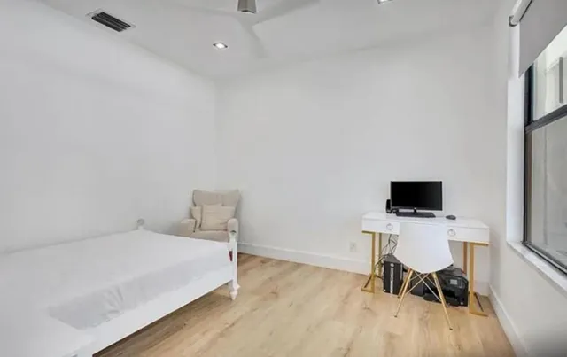 a bedroom with a bed and a chair