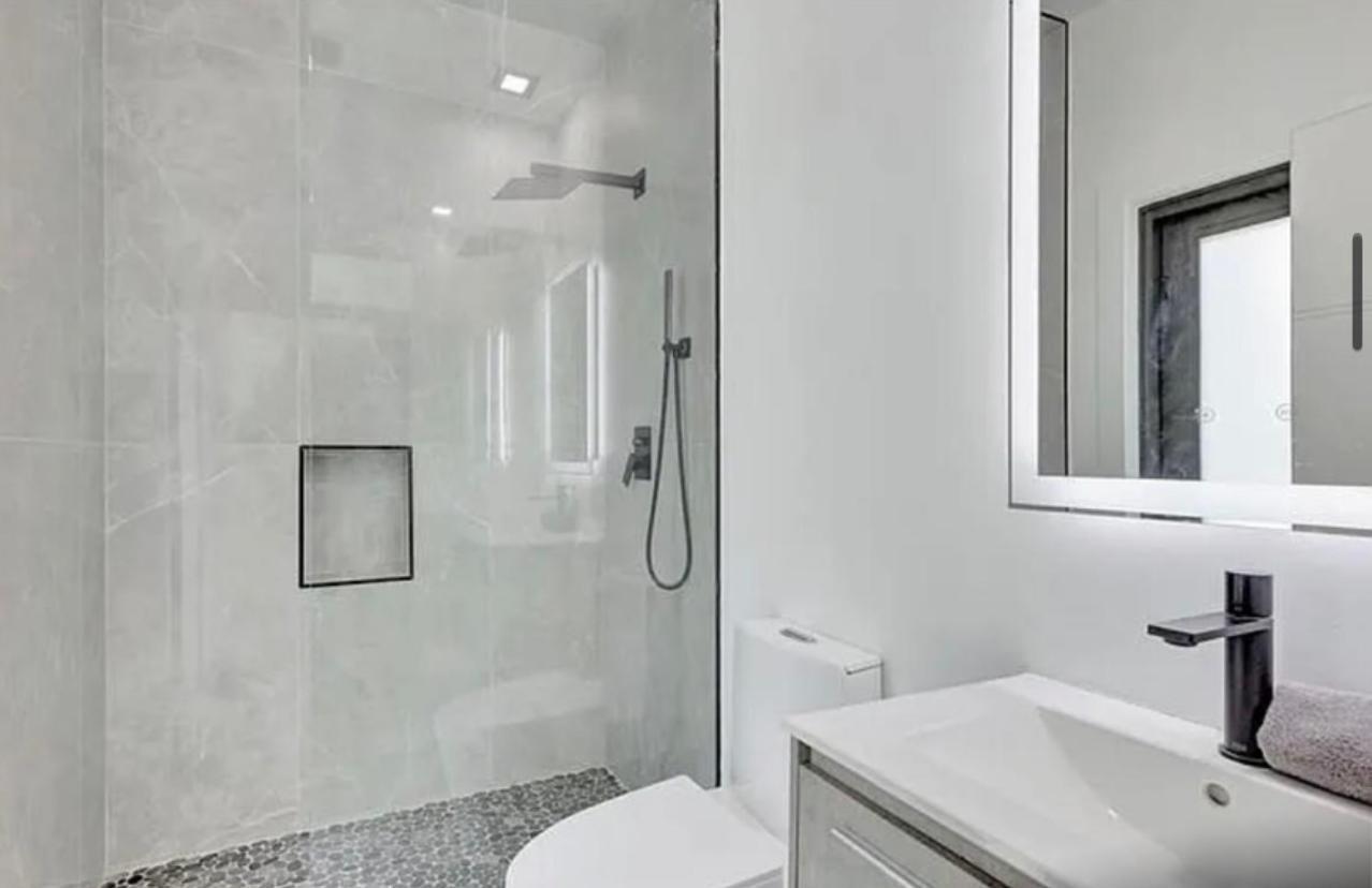 2299 Northwest 55th Street Boca Raton, FL 33496 - Photo 26 of 47 a bathroom with a sink toilet and shower