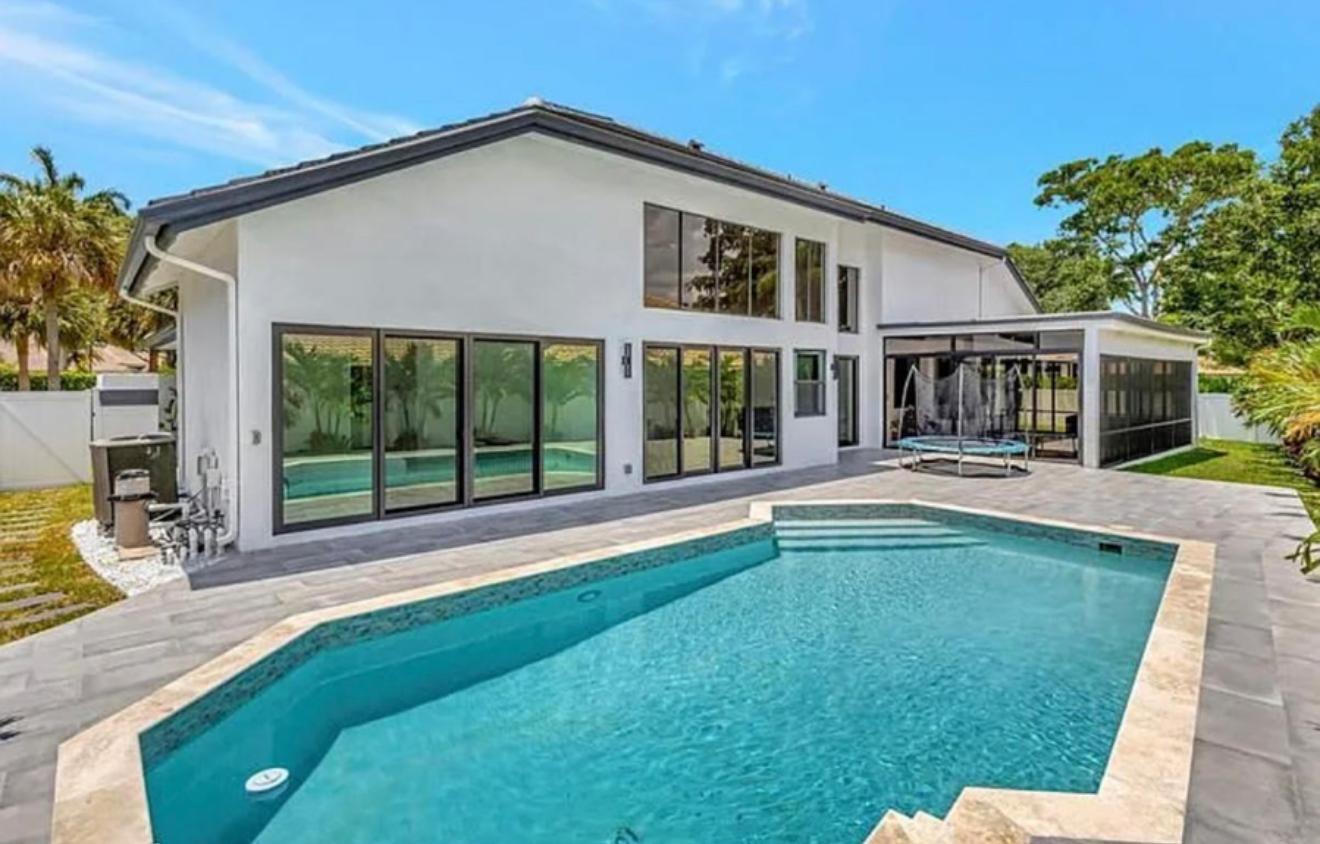 2299 Northwest 55th Street Boca Raton, FL 33496 - Photo 35 of 47 a swimming pool with outdoor seating and yard