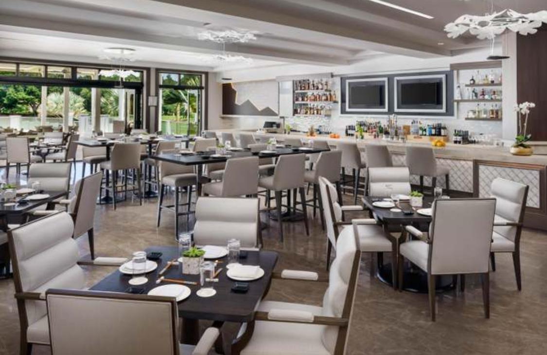 2299 Northwest 55th Street Boca Raton, FL 33496 - Photo 45 of 47 a outdoor dining space with furniture a flat screen tv and a large window