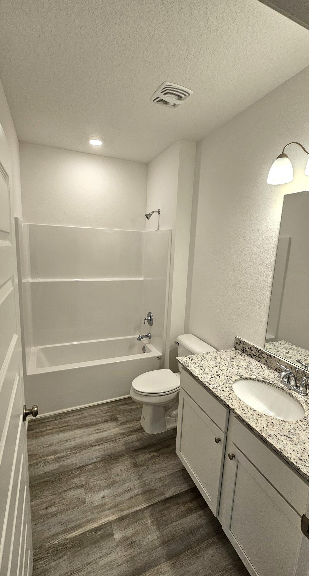 96 Sweetthorn Street Freeport, FL 32439 - Photo 14 of 18 a bathroom with a granite countertop sink toilet and shower