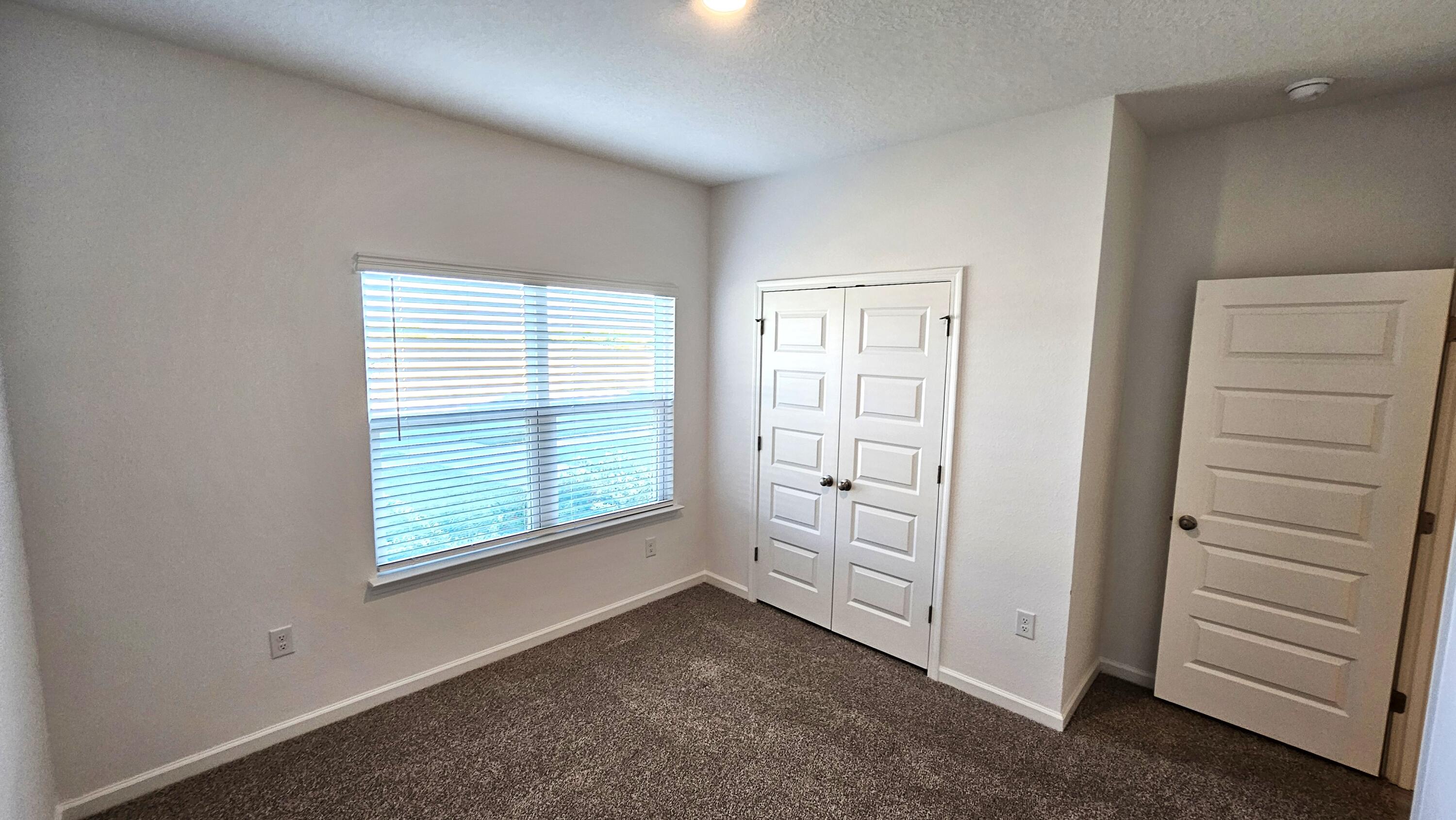 96 Sweetthorn Street Freeport, FL 32439 - Photo 16 of 18 an empty room with windows and closet