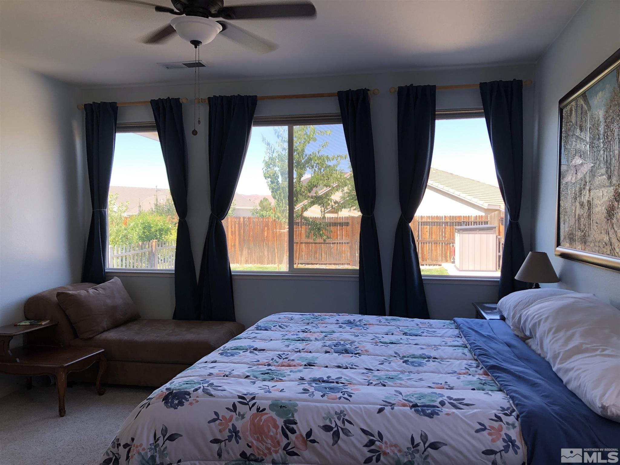 10150 Robilee Court Reno, NV 89521 - Photo 18 of 40 a bedroom with a large bed and a large window