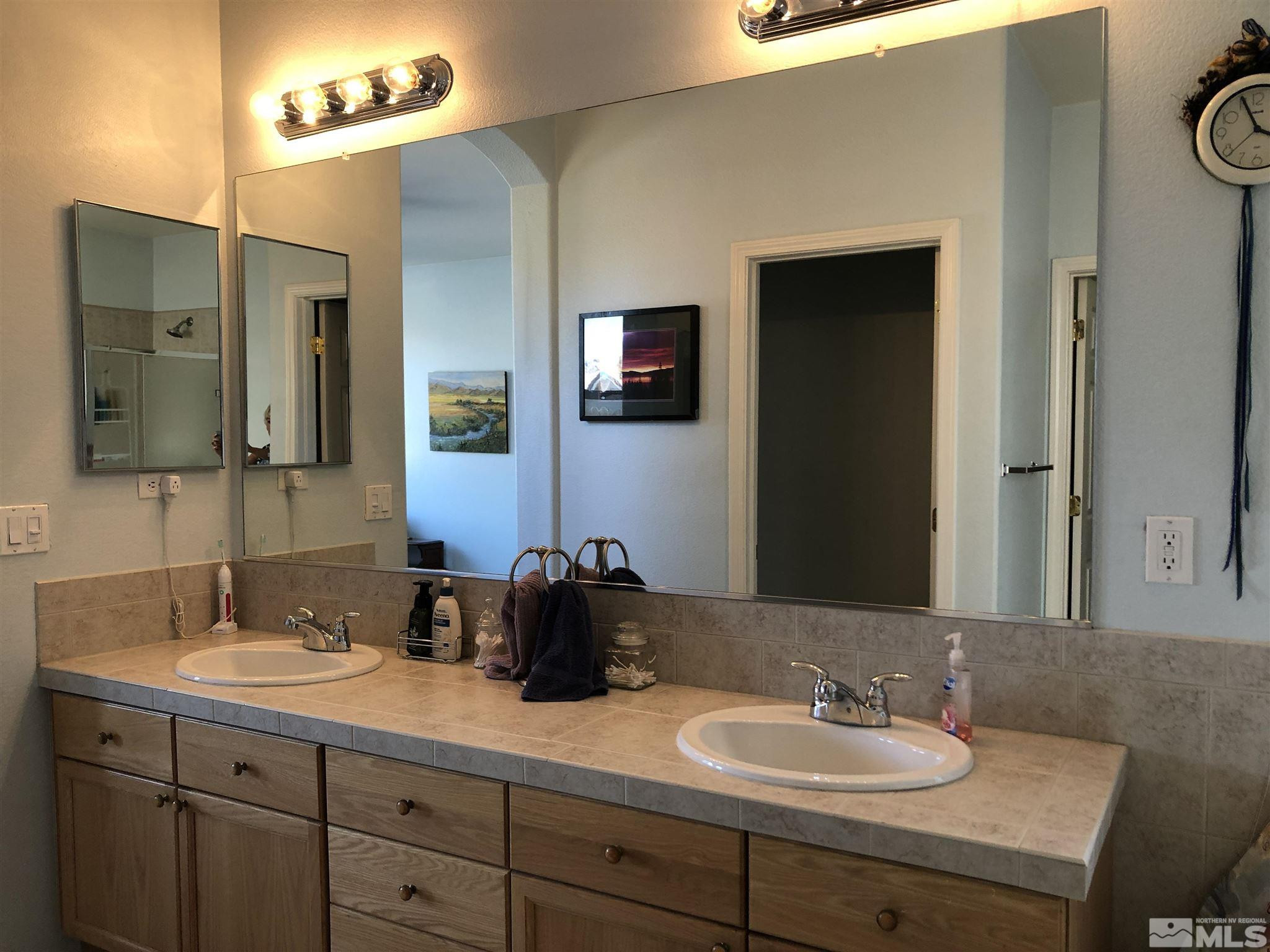 10150 Robilee Court Reno, NV 89521 - Photo 22 of 40 a bathroom with a double vanity sink and a mirror