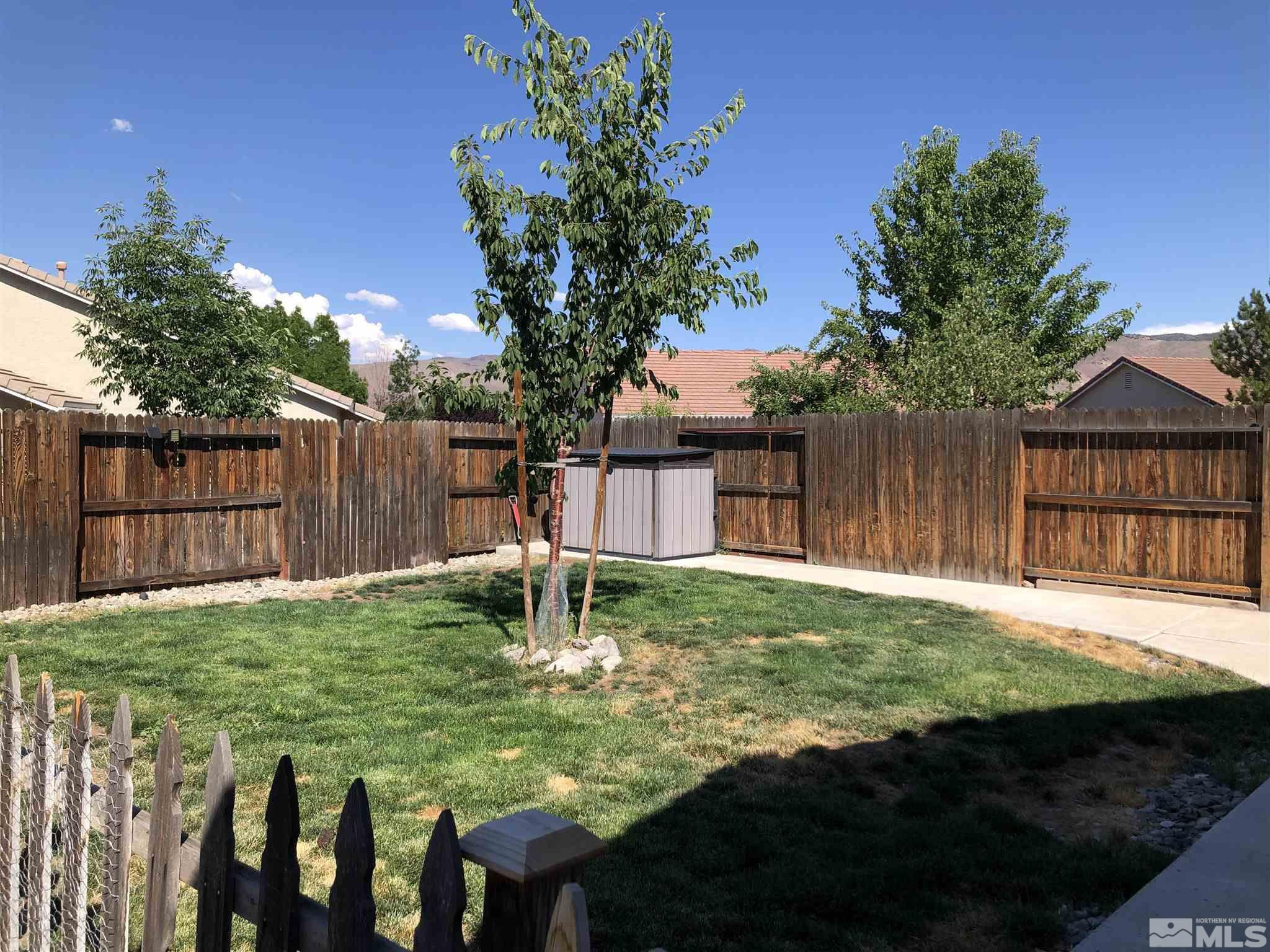 10150 Robilee Court Reno, NV 89521 - Photo 34 of 40 a view of backyard with wooden fence and a large tree