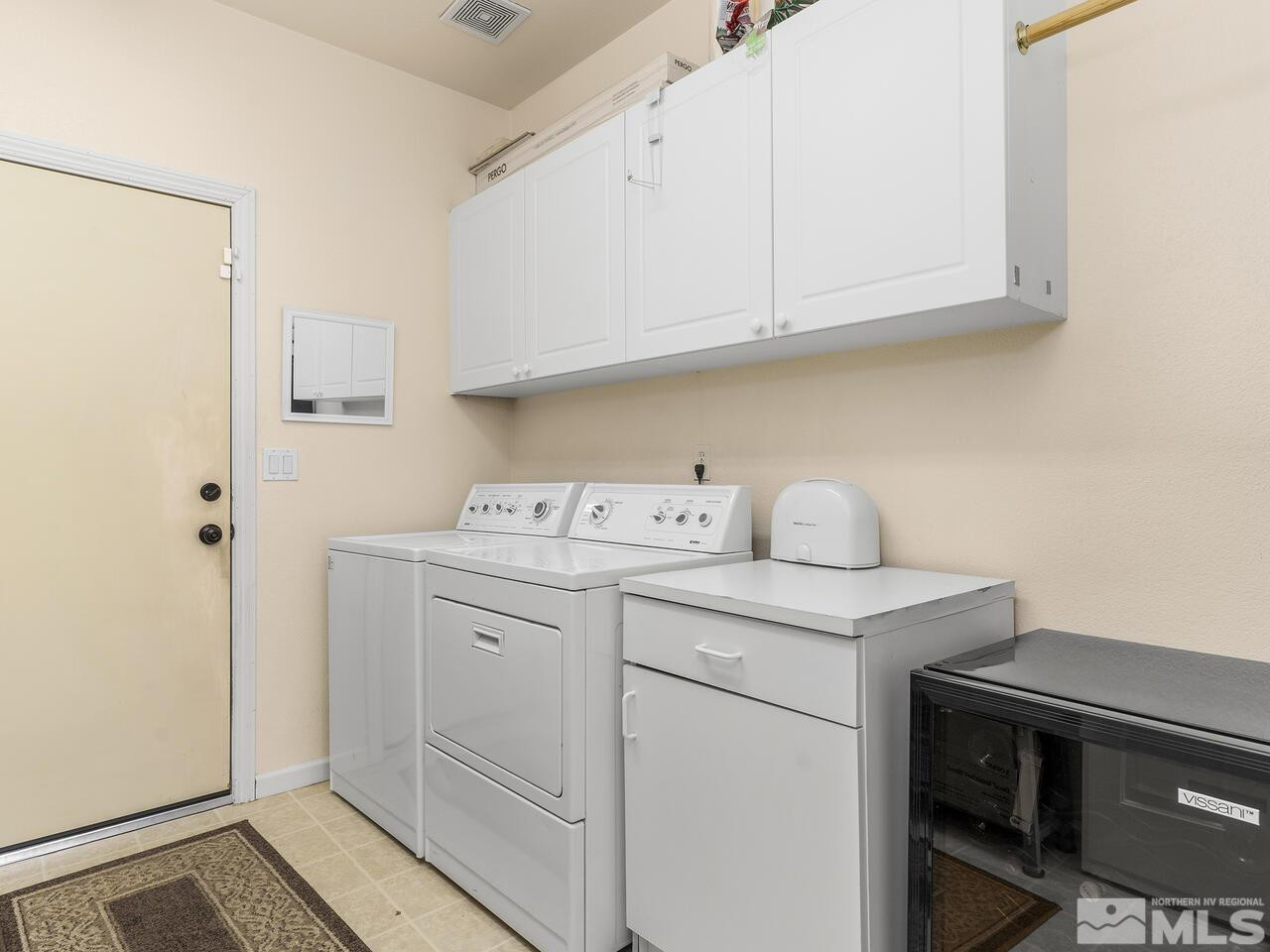10150 Robilee Court Reno, NV 89521 - Photo 39 of 40 a utility room with cabinets washer and dryer