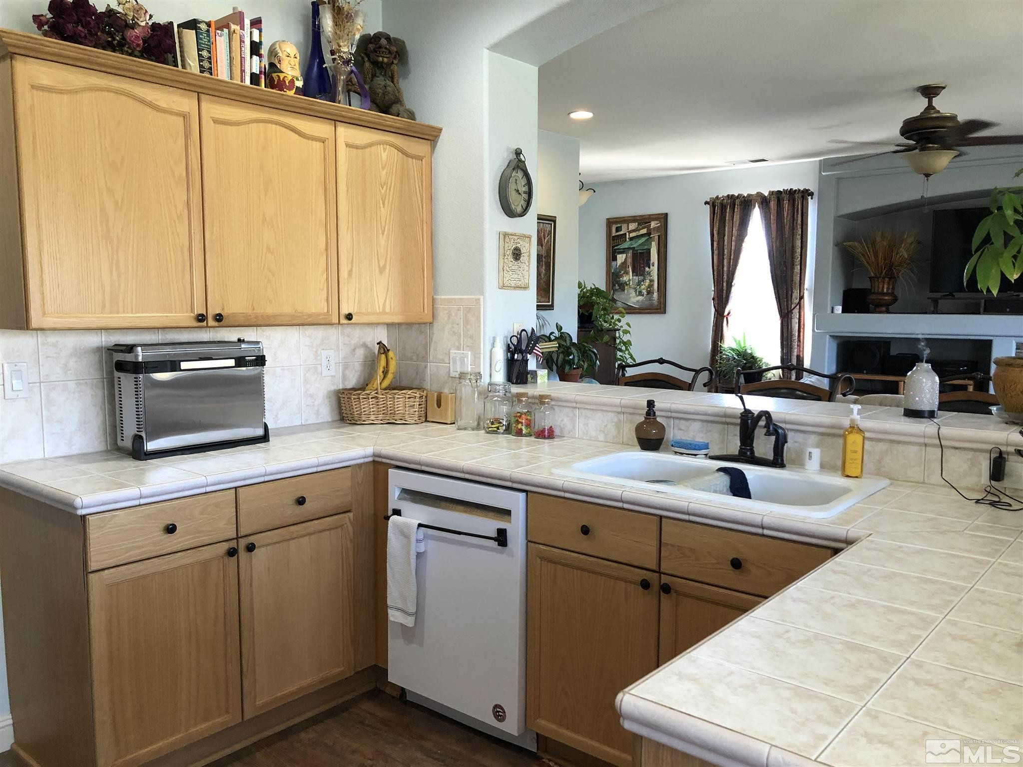 10150 Robilee Court Reno, NV 89521 - Photo 8 of 40 a kitchen with cabinets a sink and appliances