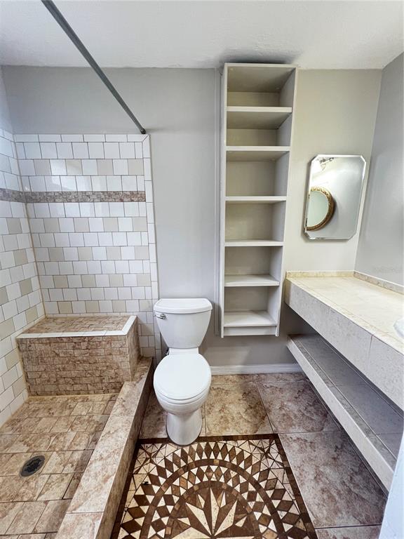 7200 Jenner Avenue New Port Richey, FL 34655 - Photo 4 of 12 a bathroom with a sink a toilet and a shower