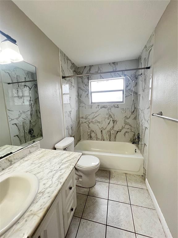 7200 Jenner Avenue New Port Richey, FL 34655 - Photo 5 of 12 a bathroom with a granite countertop sink a toilet a mirror and bathtub