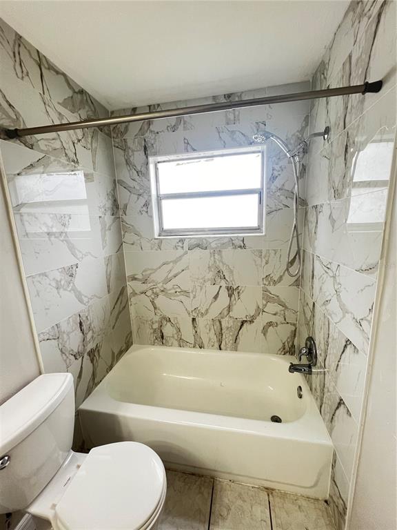 7200 Jenner Avenue New Port Richey, FL 34655 - Photo 6 of 12 a bathroom with a bathtub and a toilet