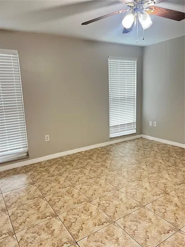 a view of empty room with floor to ceiling windows and yard