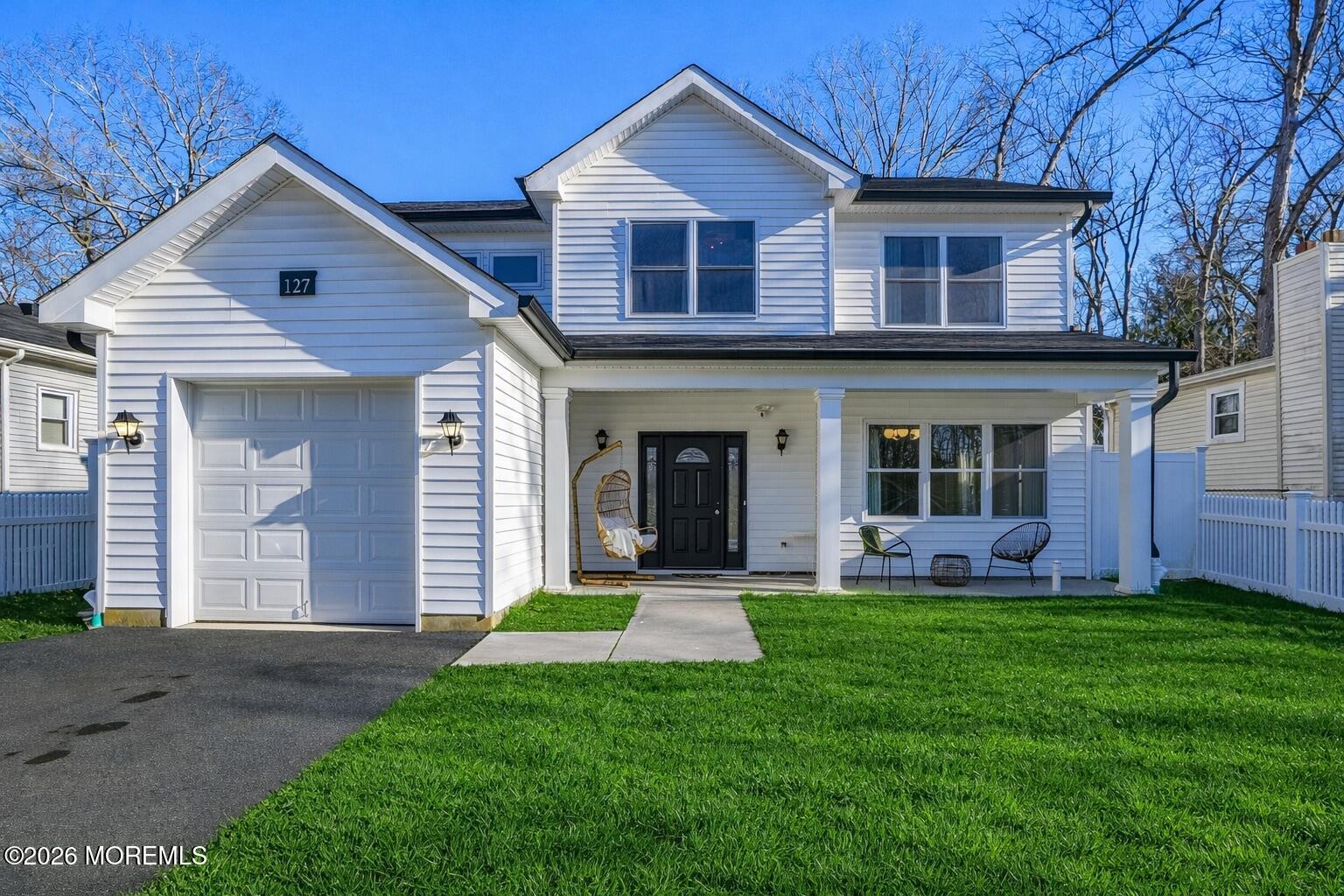 127 West 2nd Street Howell, NJ 07731 - Photo 2 of 29 a front view of a house with a yard and garage