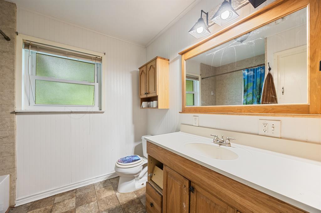571 South 1st Street Point, TX 75472 - Photo 13 of 27 a bathroom with a sink toilet and mirror