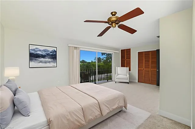 a bedroom with a large bed and a large window
