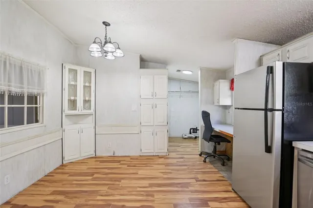 a kitchen with a stove window and cabinets