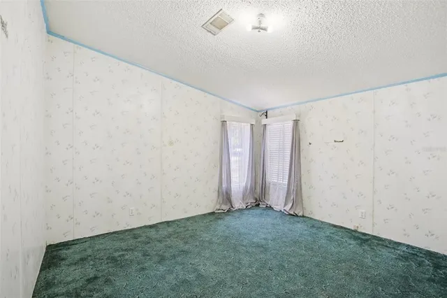 an empty room with a empty space and windows