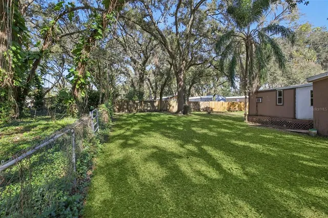 a view of a house with backyard porch and sitting area