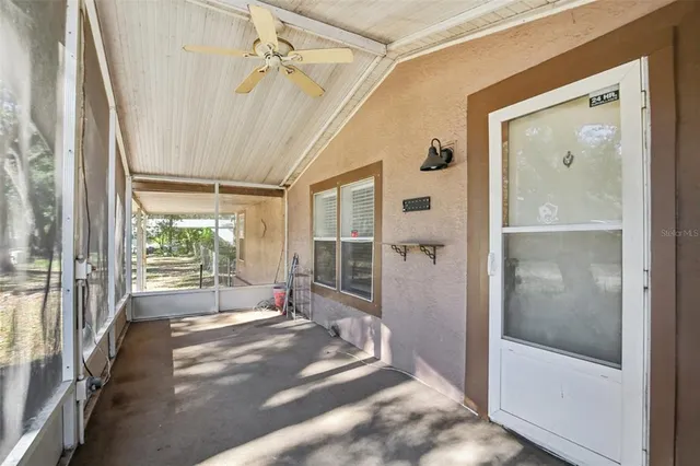 a view of empty room with wooden floor and window