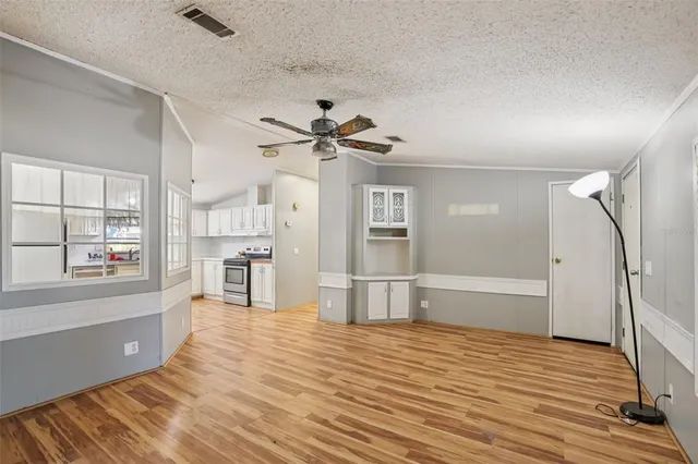 a kitchen with refrigerator and cabinets