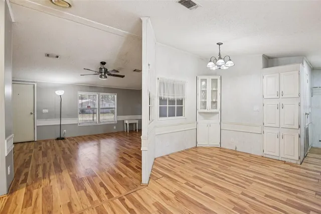 a view of kitchen with refrigerator furniture and wooden floor