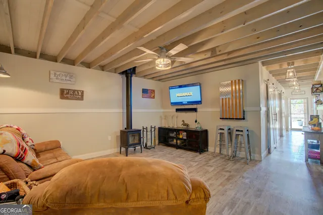 a living room with furniture and kitchen view