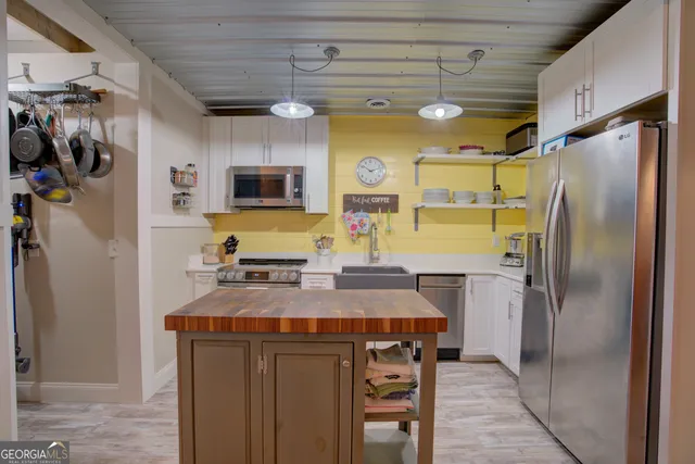 a kitchen with stainless steel appliances granite countertop a stove and a refrigerator