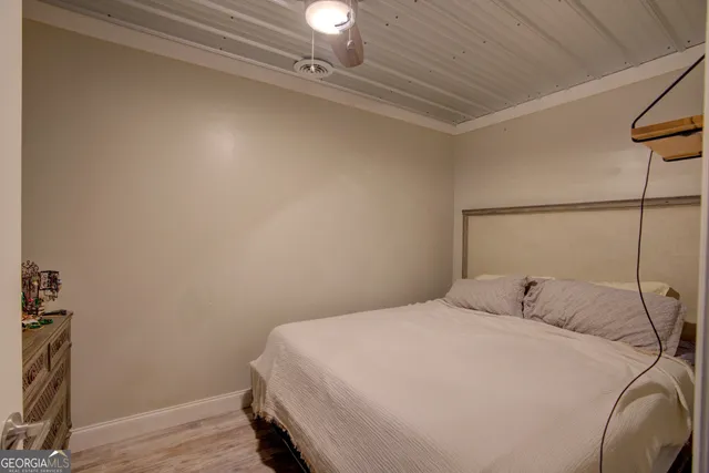 a bedroom with a bed and flat screen tv