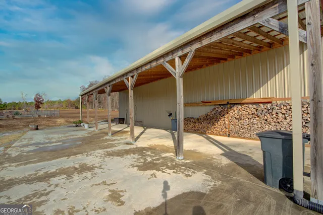 a view of a backyard with table and chairs with wooden fence