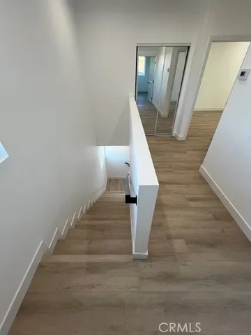 a view of entryway and hall with wooden floor
