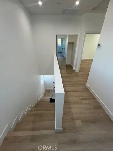 a view of entryway and hall with wooden floor