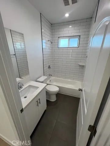 a bathroom with a double vanity sink toilet and shower