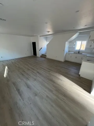 a view of a room with wooden floor