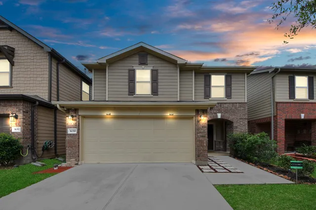 a front view of a house with a yard and garage